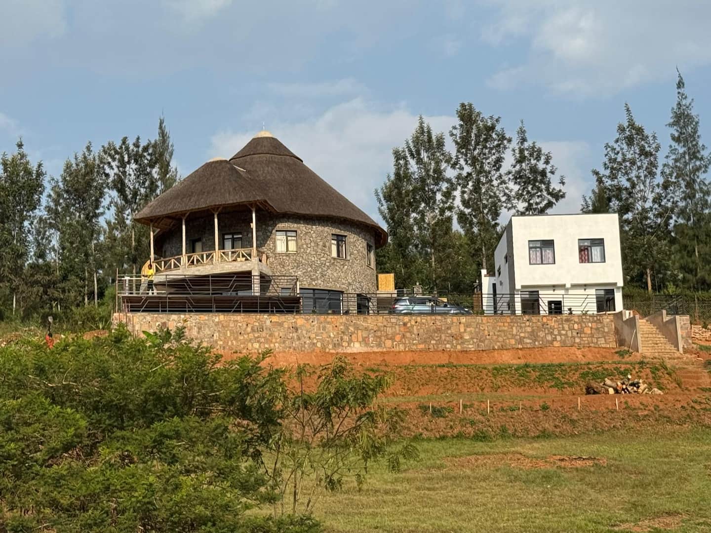 The round house and the modern annexe together above Lake Muhazi