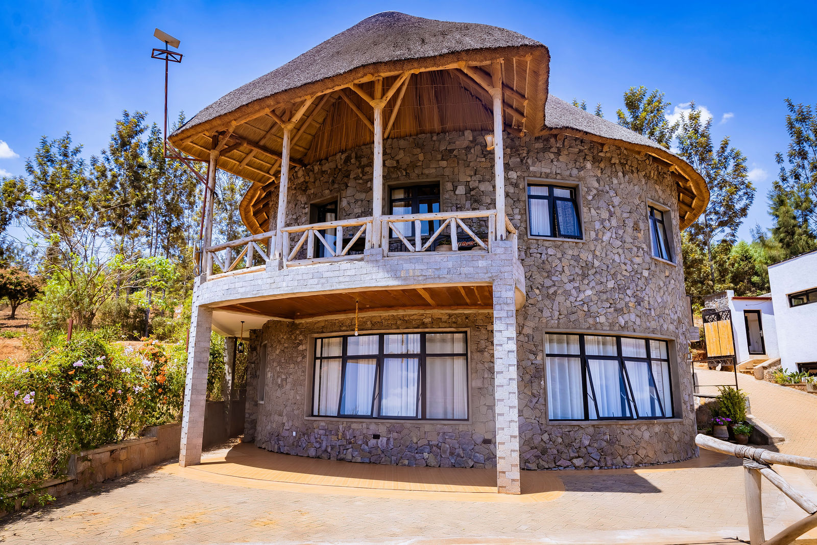The thatched stone round house above Lake Muhazi