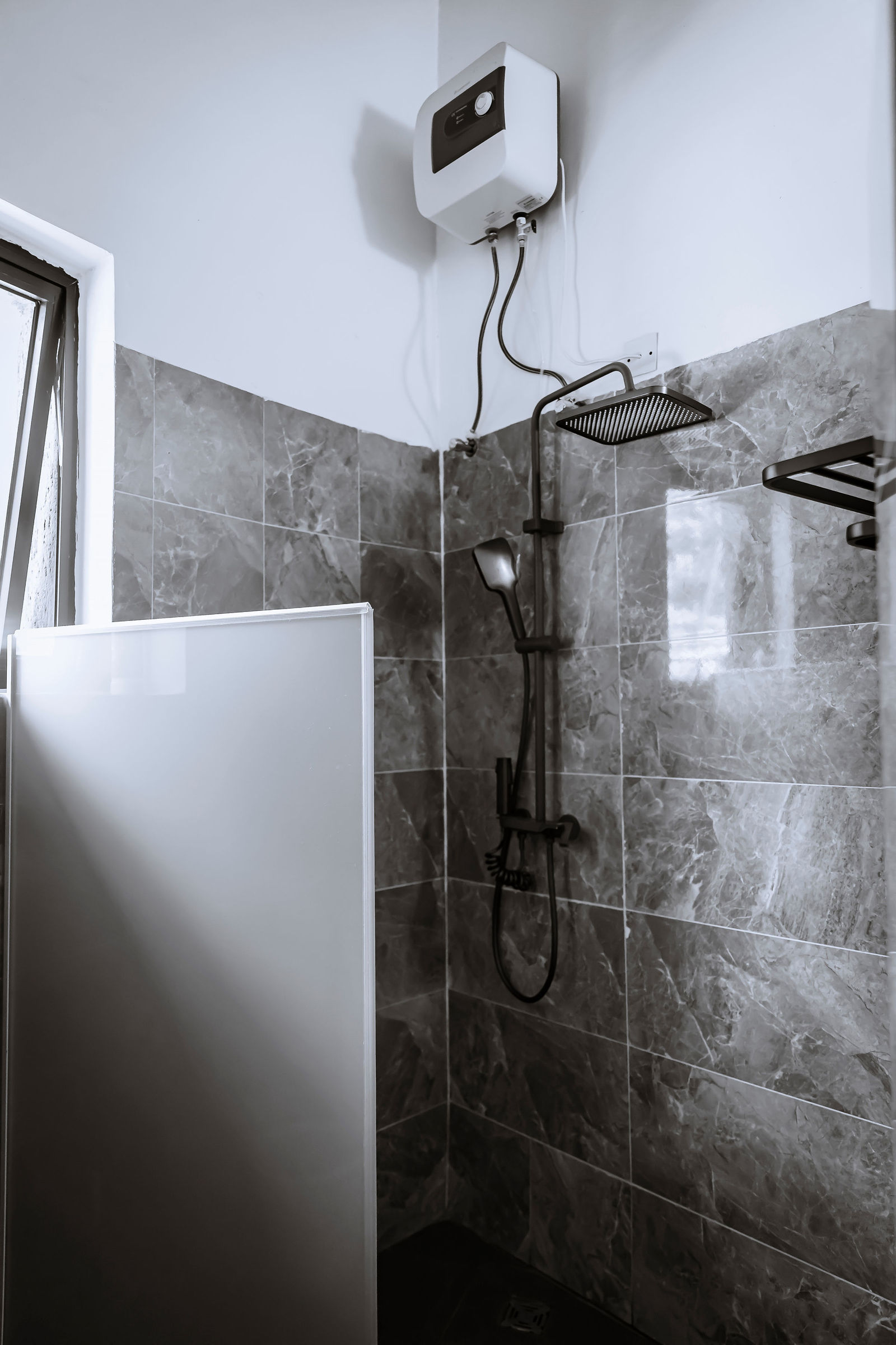 Walk-in shower with grey stone tiling